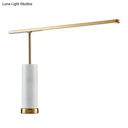 Gold marble nightstand lamp with white cylindrical shade and brass accents on Tampa Home & Garden Store