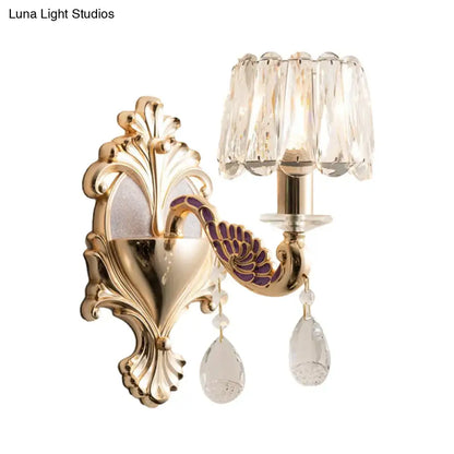Gold peacock wall sconce by Decorbites with ornate backplate and crystal shade on Tampa Home & Garden Store