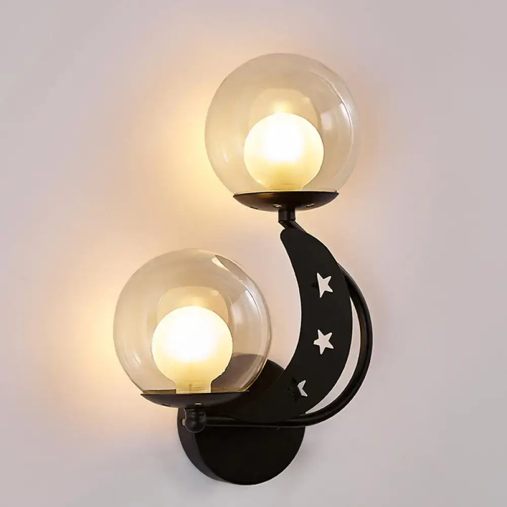Decorbites Gold Ball Wall Sconce with two glass globes on curved black arm with star cutouts on Tampa Home & Garden Store