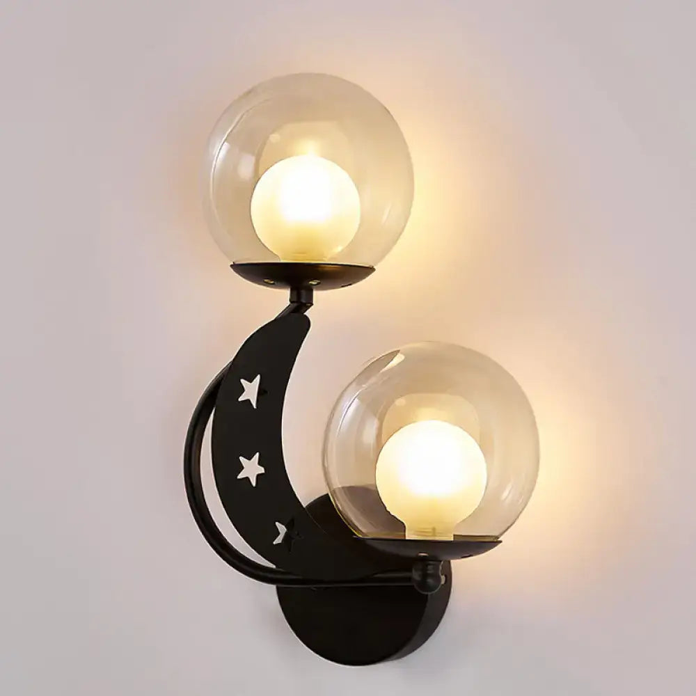 Decorbites Gold Ball Wall Sconce with dual glass globes on a black curved mount featuring star cutouts on Tampa Home & Garden Store