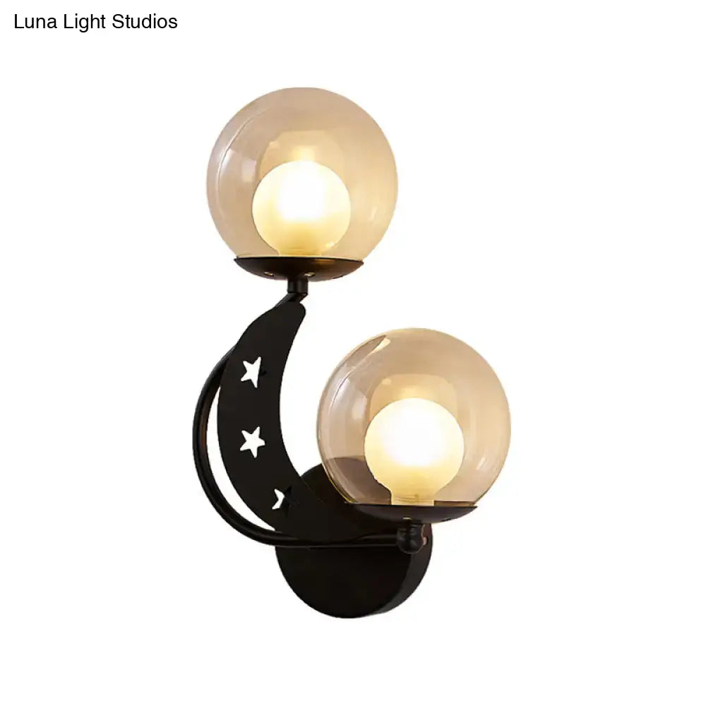 Gold Ball Wall Sconce by Decorbites with two globes on curved black metal arm star cutouts on Tampa Home & Garden Store