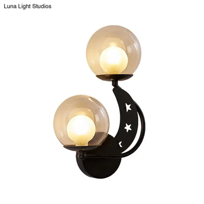 Gold Ball Wall Sconce by Decorbites featuring twin amber glass globes on a black curved arm on Tampa Home & Garden Store