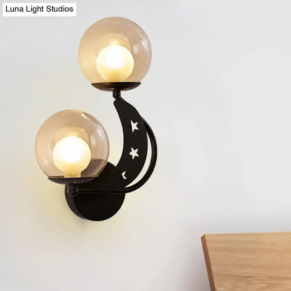 Decorbites Gold Ball Wall Sconce with twin glass globe bulbs and black curved backplate on Tampa Home & Garden Store