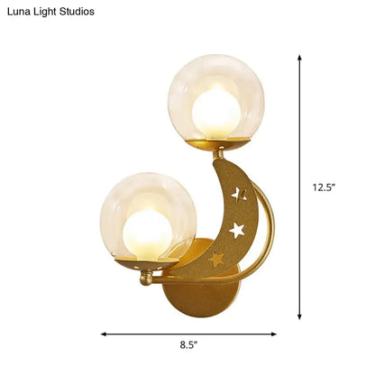 Gold Ball Wall Sconce by Decorbites, twin glass globes on curved gold arc with star cutouts on Tampa Home & Garden Store
