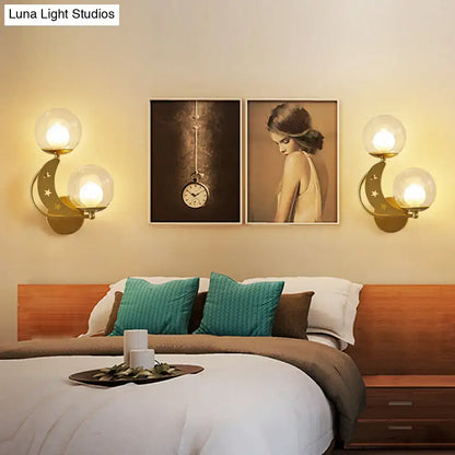 Decorbites Gold Ball Wall Sconce pair with glass globe bulbs on gold crescent backplates on Tampa Home & Garden Store