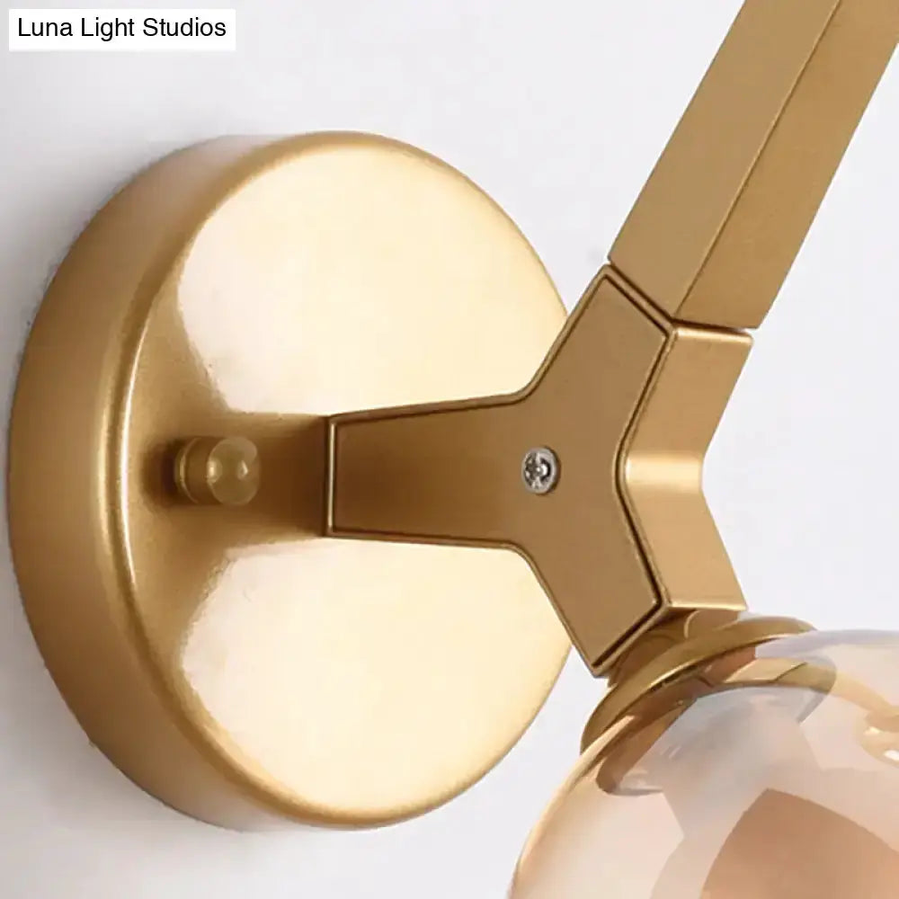 Modern gold double globe wall lamp with round backplate and clear glass globes for hallway on Tampa Home & Garden Store