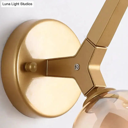 Modern gold double globe wall lamp with round backplate and clear glass globes for hallway on Tampa Home & Garden Store