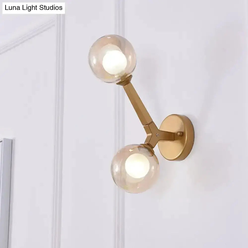 Gold brass double globe wall sconce with two glass globes for corridor lighting on Tampa Home & Garden Store