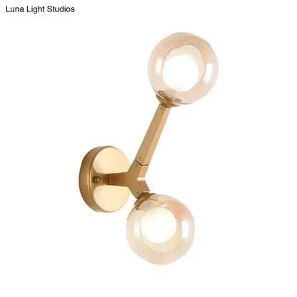 Decorbites modern gold double-globe wall lamp with brass finish and two glass globes on Tampa Home & Garden Store