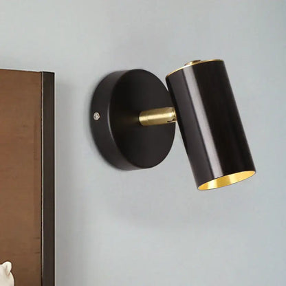 Decorbites Bedside LED Sconce, black cylindrical shade with brass interior on wall mount on Tampa Home & Garden Store