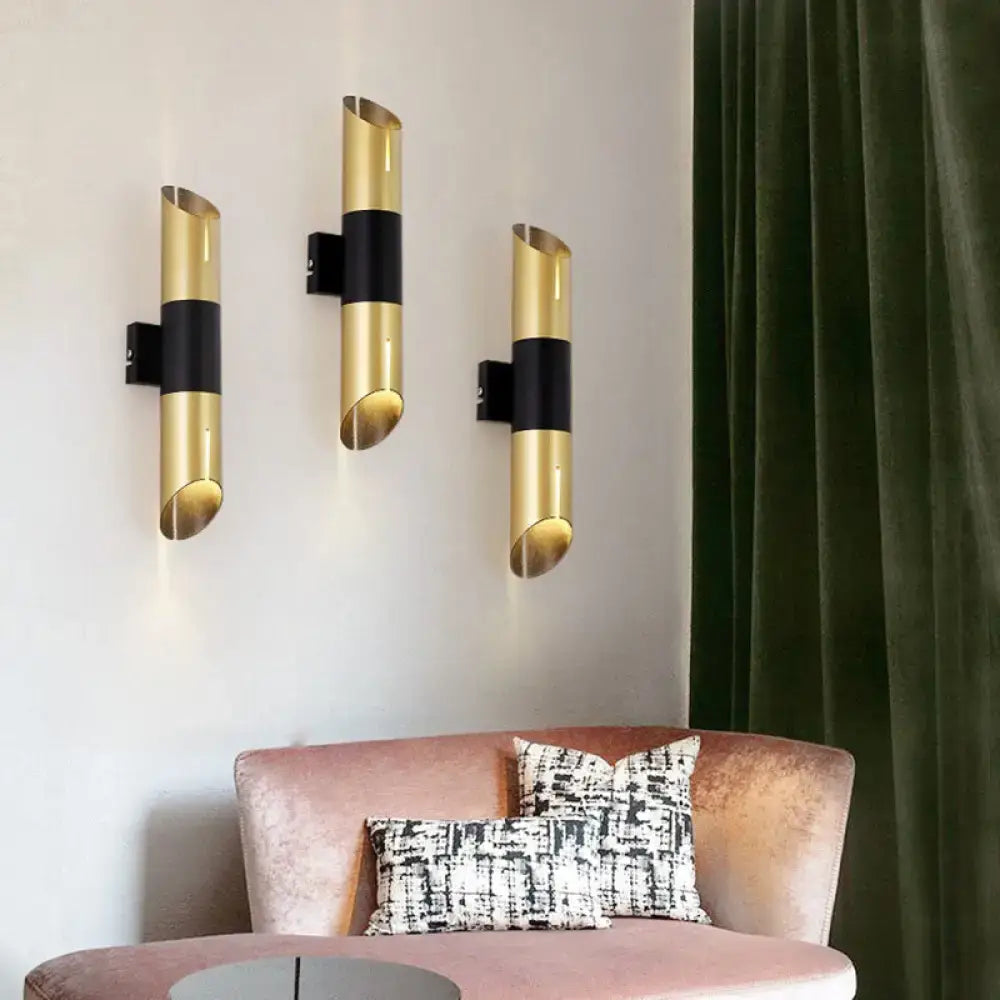 Decorbites gold black cylinder wall sconce set of three mounted on white wall on Tampa Home & Garden Store