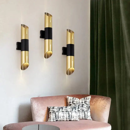 Decorbites gold black cylinder wall sconce set of three mounted on white wall on Tampa Home & Garden Store
