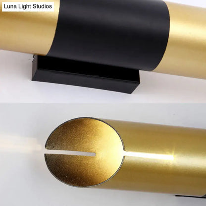 Gold black cylinder wall sconce by Decorbites with a black mounting base on Tampa Home & Garden Store