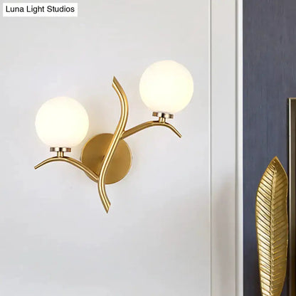 Modern gold branch wall light fixture with two frosted glass globes Decorbites on Tampa Home & Garden Store