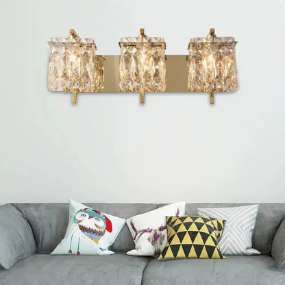 Decorbites modern gold and crystal wall light with 3 cube crystal shades on a gold backplate on Tampa Home & Garden Store