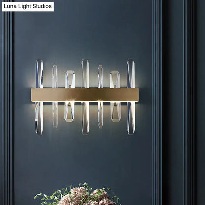 Gold crystal bar sconce with hanging prisms by Decorbites on dark wall on Tampa Home & Garden Store