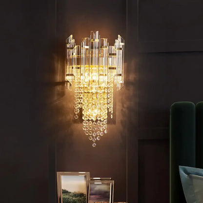 Gold crystal tiered sconce with cascading prisms and warm amber glow Decorbites on Tampa Home & Garden Store