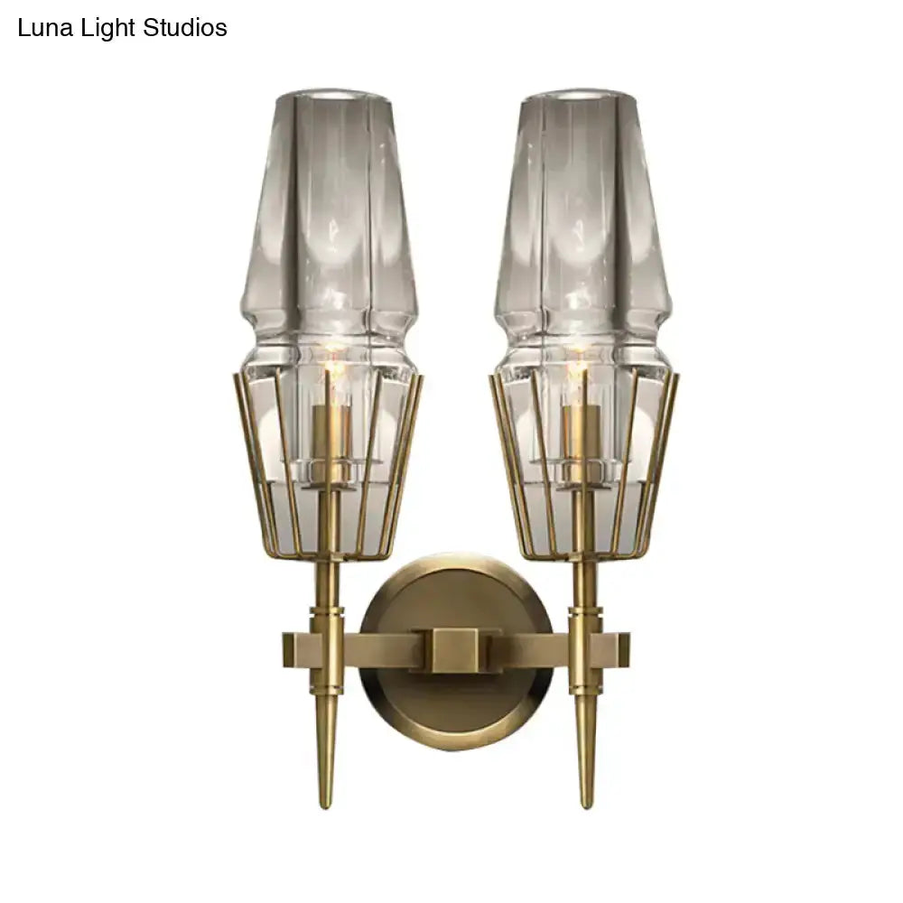 Modern gold clear glass two-light wall sconce with geometric wire cages and brass backplate on Tampa Home & Garden Store