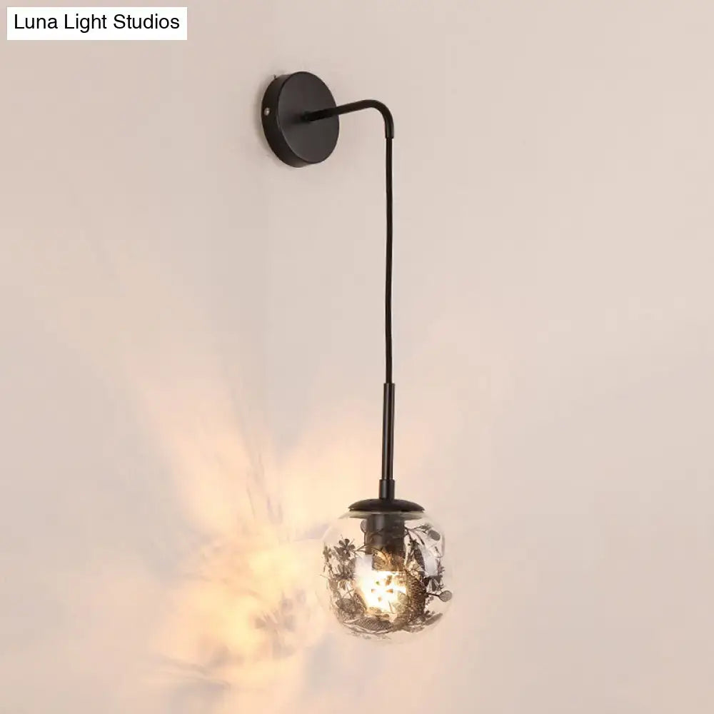 Gold Glass Orb Wall Light with black metal mount and floral filigree glass globe Decorbites on Tampa Home & Garden Store