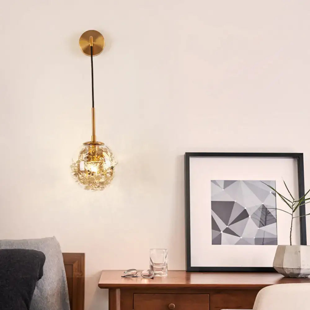 Gold Glass Orb Wall Light pendant with brass stem, warm glow on Tampa Home & Garden Store