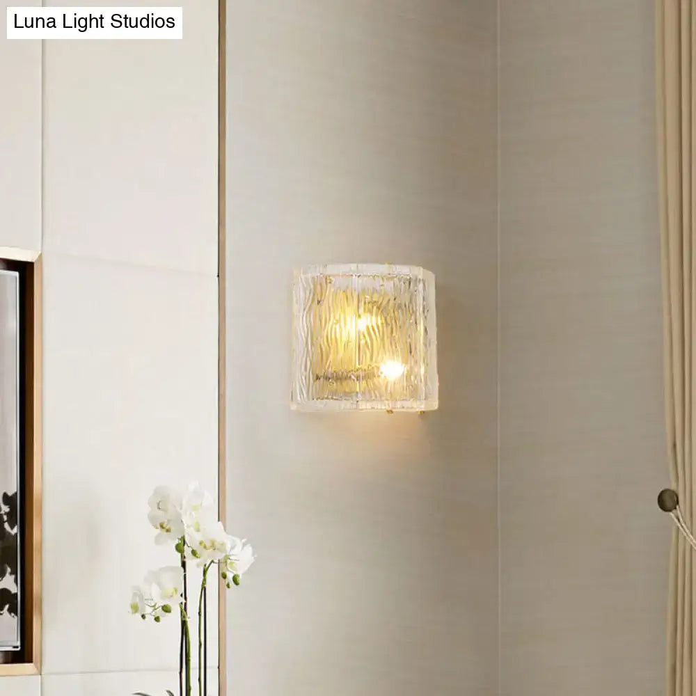 Gold ripple glass sconce with warm yellow glow on pale wall on Tampa Home & Garden Store