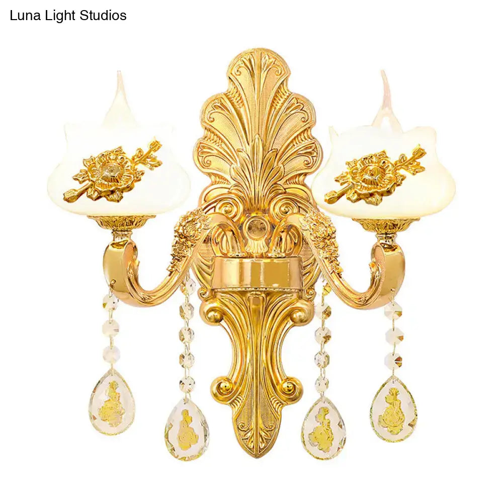 Modern gold crystal droplet two-light bedroom wall sconce with ornate backplate and teardrop prisms on Tampa Home & Garden Store