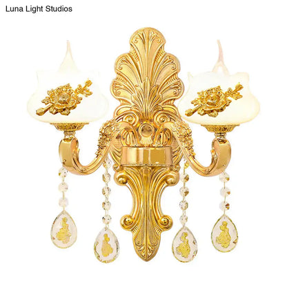 Modern gold crystal droplet two-light bedroom wall sconce with ornate backplate and teardrop prisms on Tampa Home & Garden Store