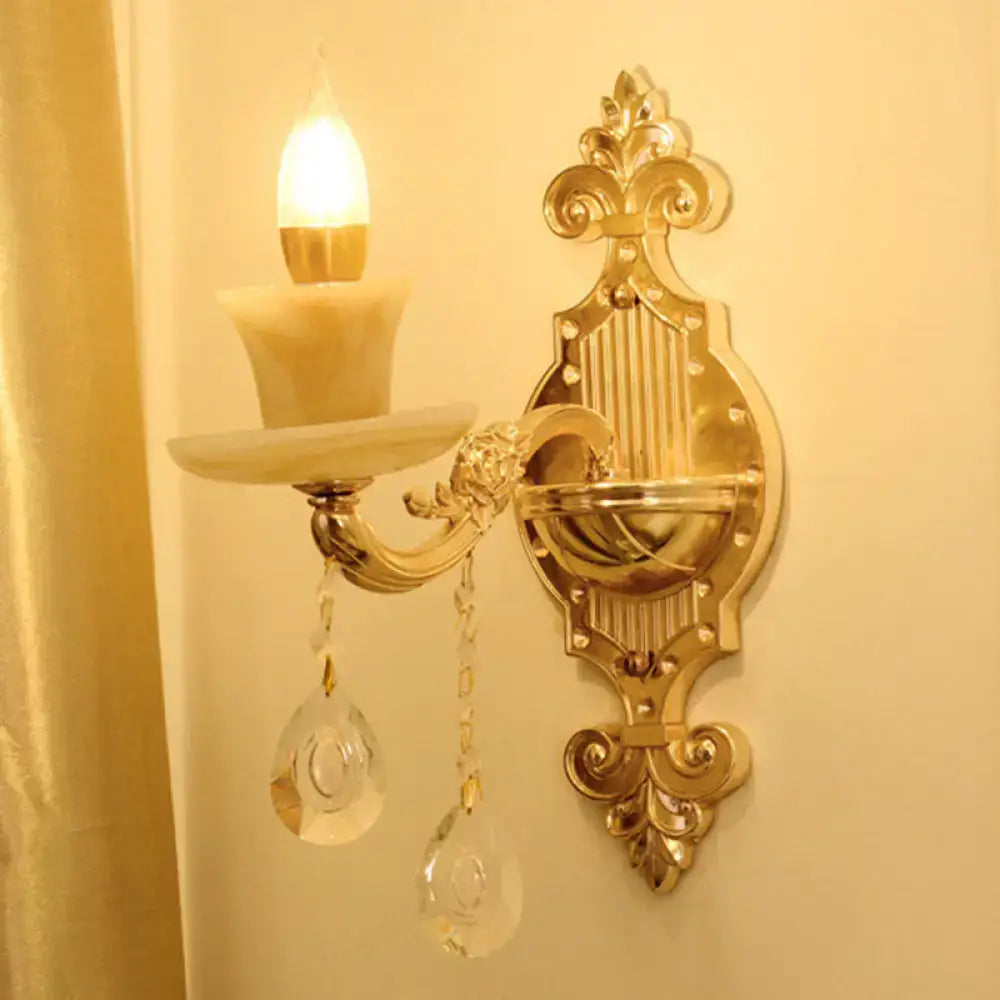 Modern gold crystal droplet wall sconce from Decorbites with candle bulb and ornate backplate on Tampa Home & Garden Store