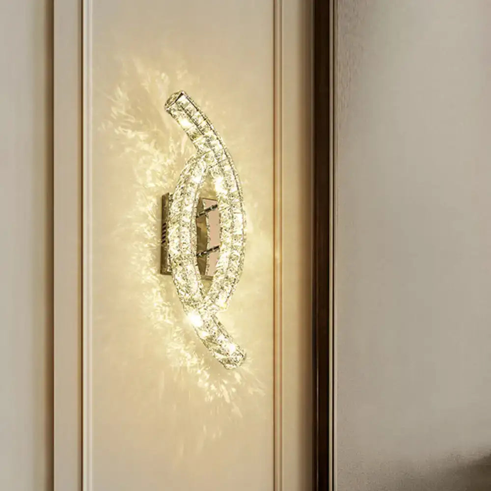 Gold crystal leaf sconce by Decorbites; curved crystal leaf wall light with warm glow on Tampa Home & Garden Store