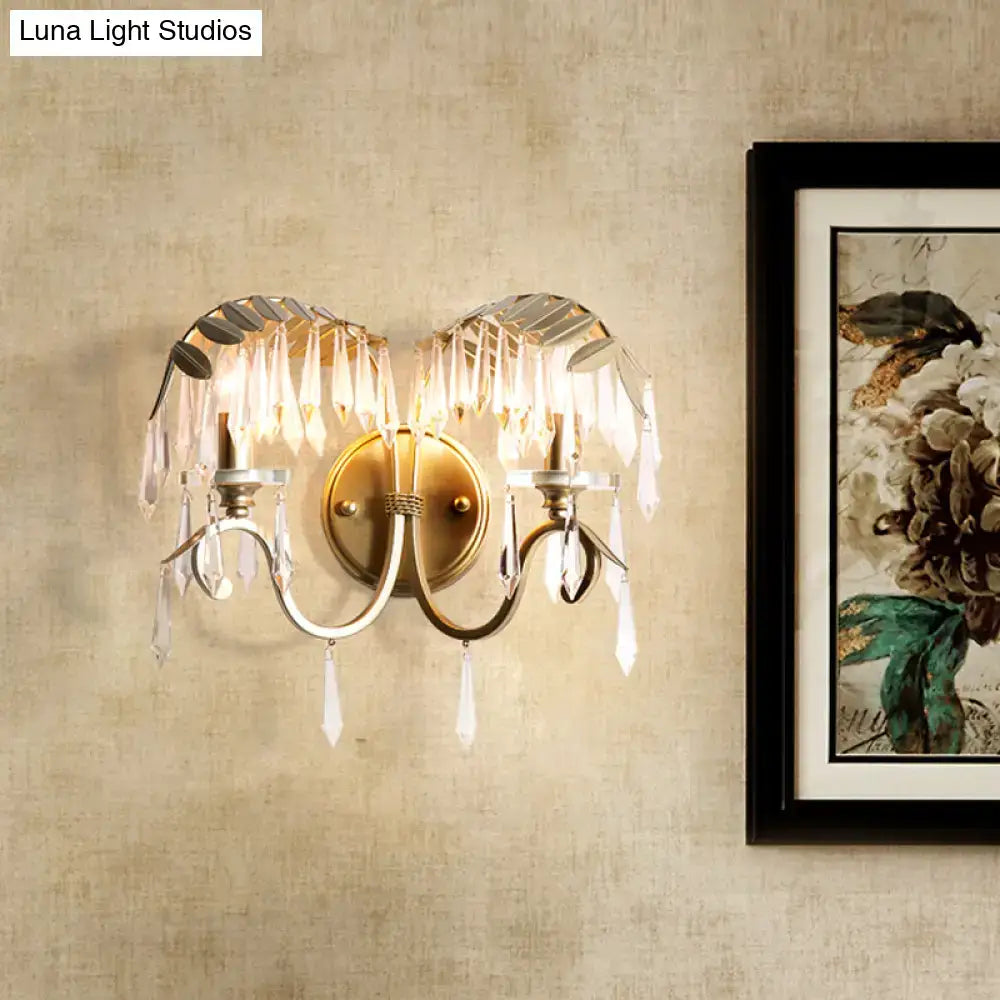 Gold bent-arm two-light wall sconce with crystal prisms and brass finish Decorbites on Tampa Home & Garden Store