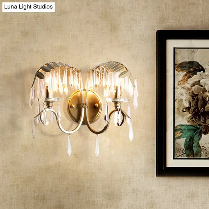 Gold bent-arm two-light wall sconce with crystal prisms and brass finish Decorbites on Tampa Home & Garden Store