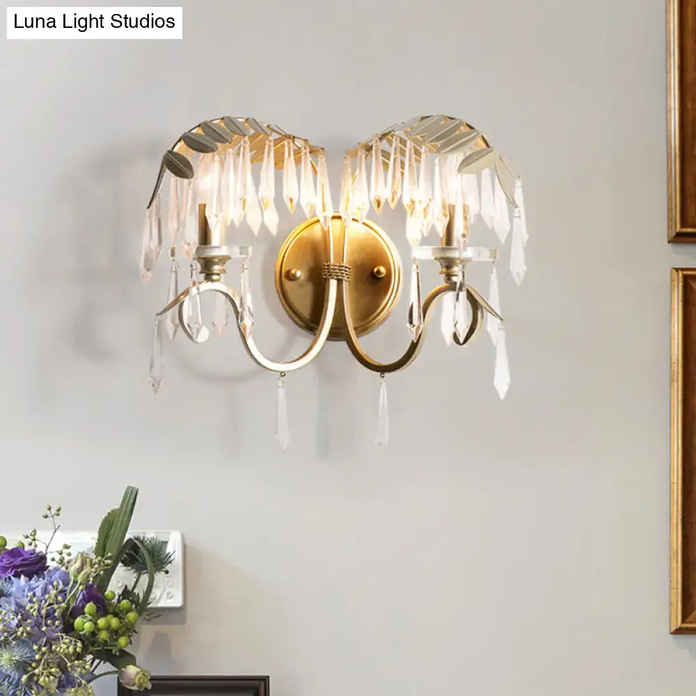 Decorbites gold bent-arm wall sconce with crystal prisms and brass backplate on Tampa Home & Garden Store