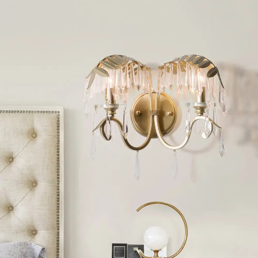 Gold bent-arm wall sconce by Decorbites with crystal fringe and dual candle lamps on Tampa Home & Garden Store