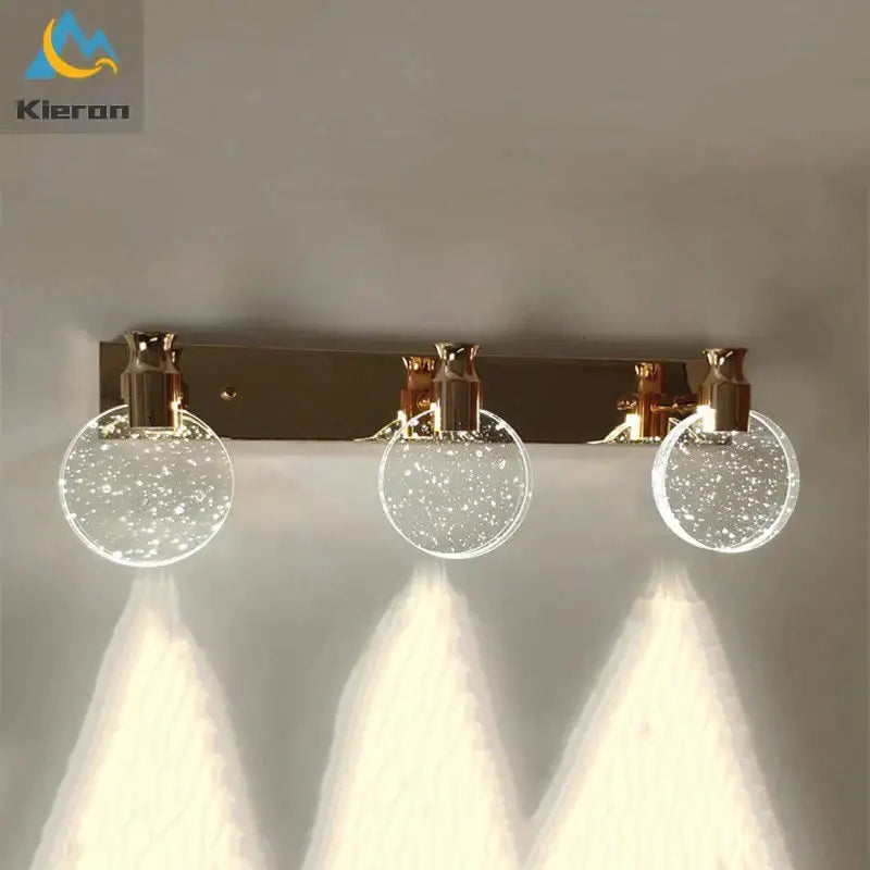 Gold three-globe wall light with brass bar and speckled glass globes by Decorbites on Tampa Home & Garden Store