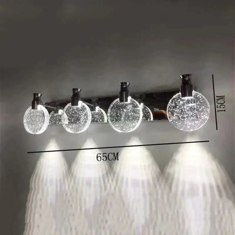 Gold three-globe wall light by Decorbites with glass globes on Tampa Home & Garden Store