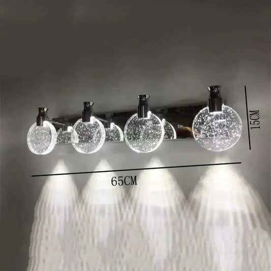 Gold three-globe wall light by Decorbites with glass globes on Tampa Home & Garden Store