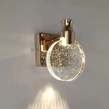 Gold wall light by Decorbites with round glass globe and bubble speckles on Tampa Home & Garden Store