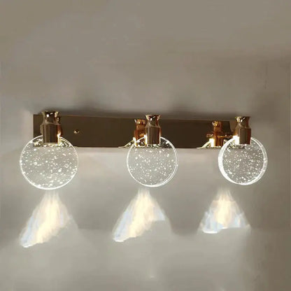 Gold Three Globe Wall Light with three glass globes in a gold finish on Tampa Home & Garden Store