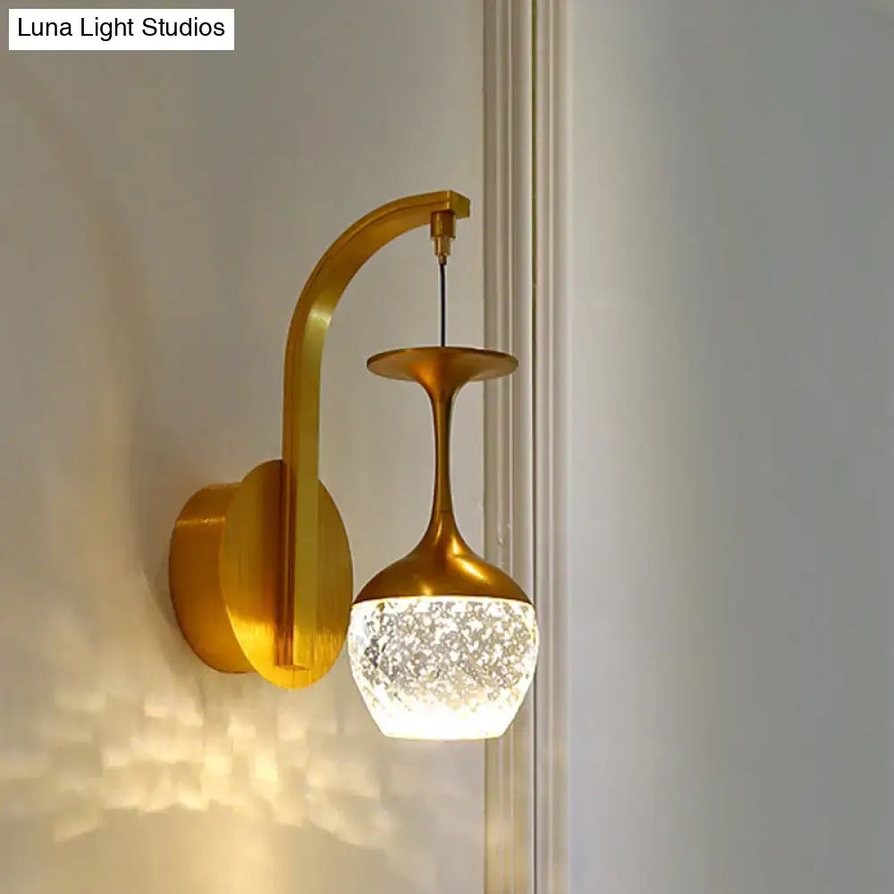 Decorbites gold crystal dimmable bedroom sconce with curved brass arm and speckled glass shade on Tampa Home & Garden Store
