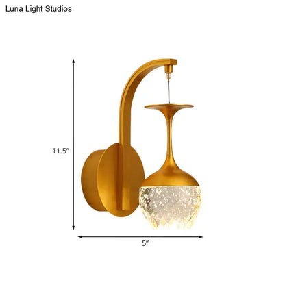 Gold crystal dimmable bedroom sconce with curved brass arm and crystal shade by Decorbites on Tampa Home & Garden Store