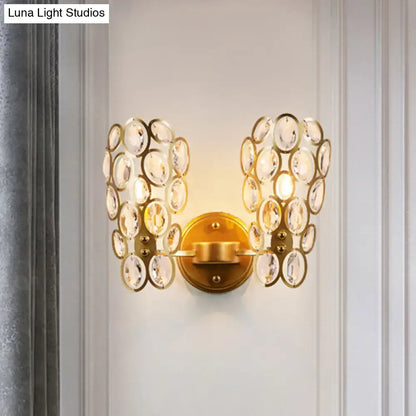 Gold cascading crystal sconce with dual disk clusters on brass backplate wall mount on Tampa Home & Garden Store