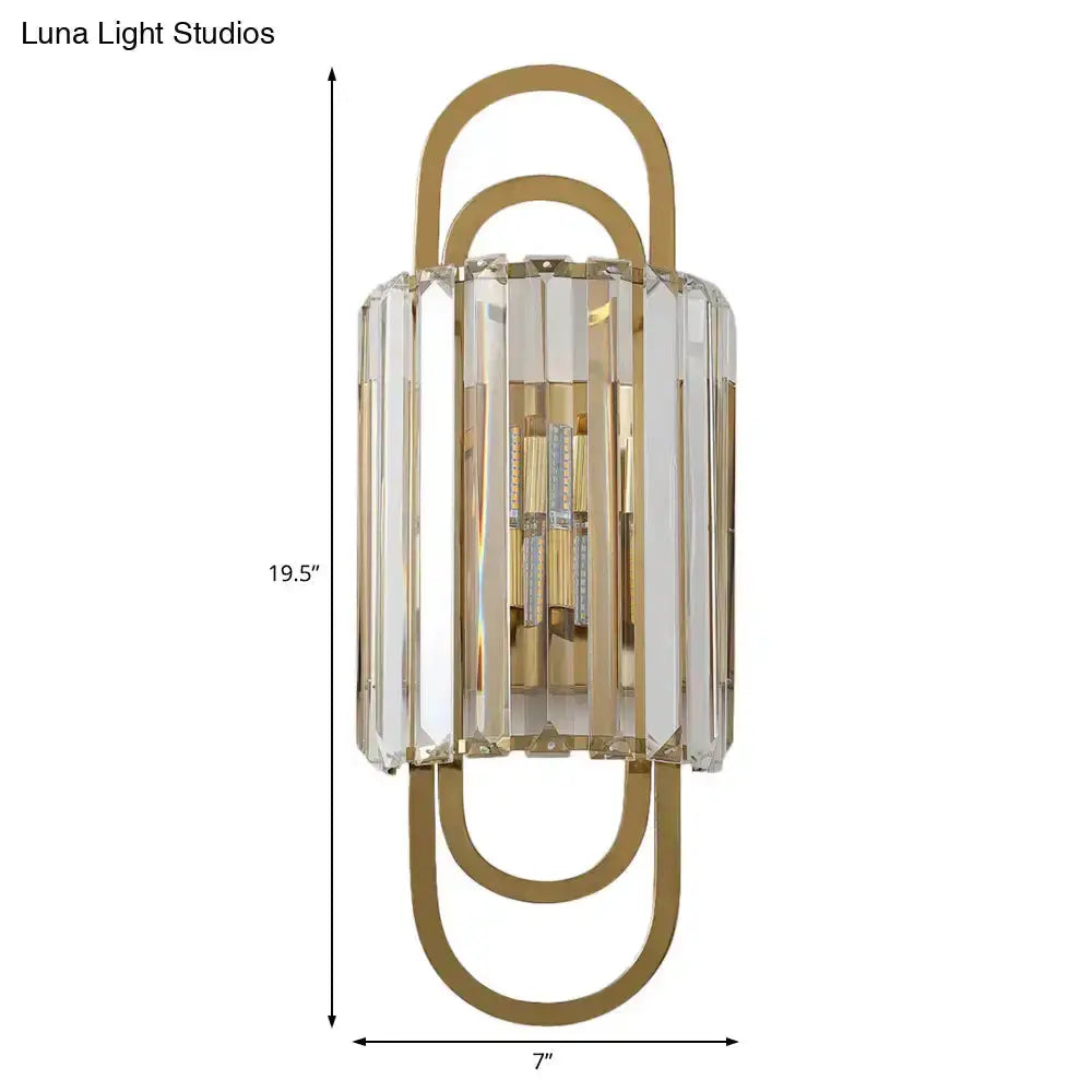 Modern gold crystal wall lamp with clear faceted prisms and curved gold frame on Tampa Home & Garden Store