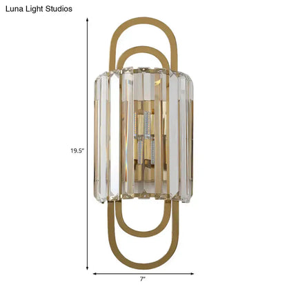 Modern gold crystal wall lamp with clear faceted prisms and curved gold frame on Tampa Home & Garden Store