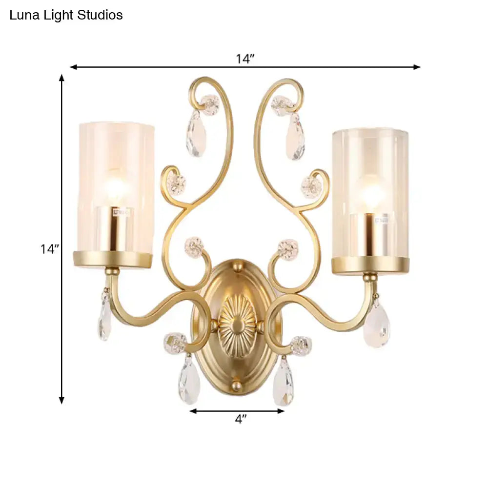 Gold cylinder wall light by Decorbites with dual arms and crystal drops on Tampa Home & Garden Store