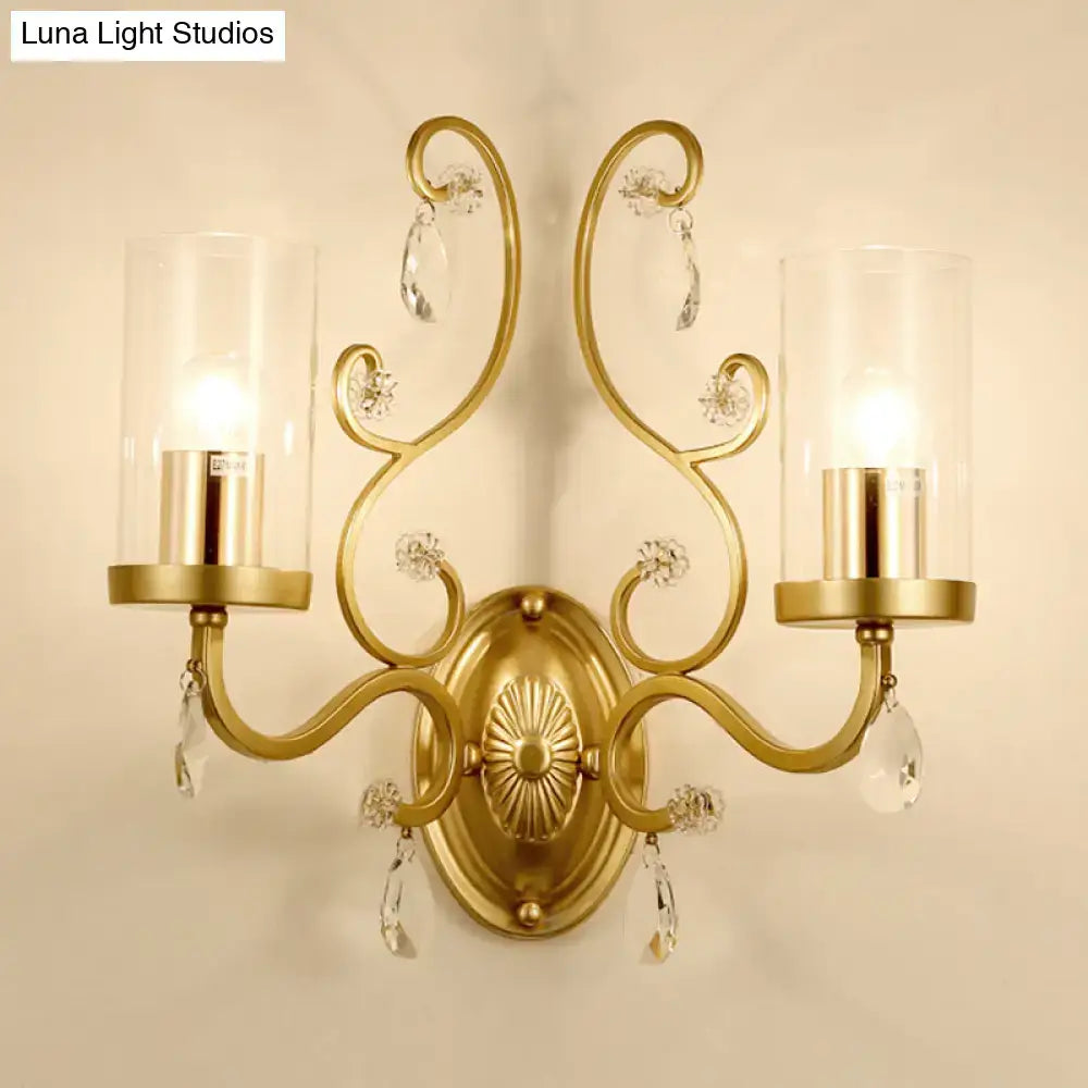 Gold cylinder wall light sconce with two arms, clear glass shades and crystal drops on Tampa Home & Garden Store