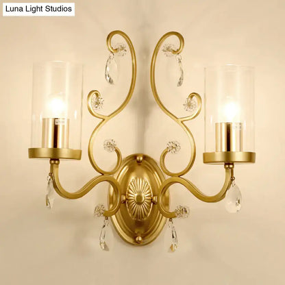 Gold cylinder wall light sconce with two arms, clear glass shades and crystal drops on Tampa Home & Garden Store
