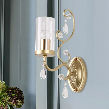 Gold cylinder wall light by Decorbites with glass shade and crystal drops on brass mount on Tampa Home & Garden Store