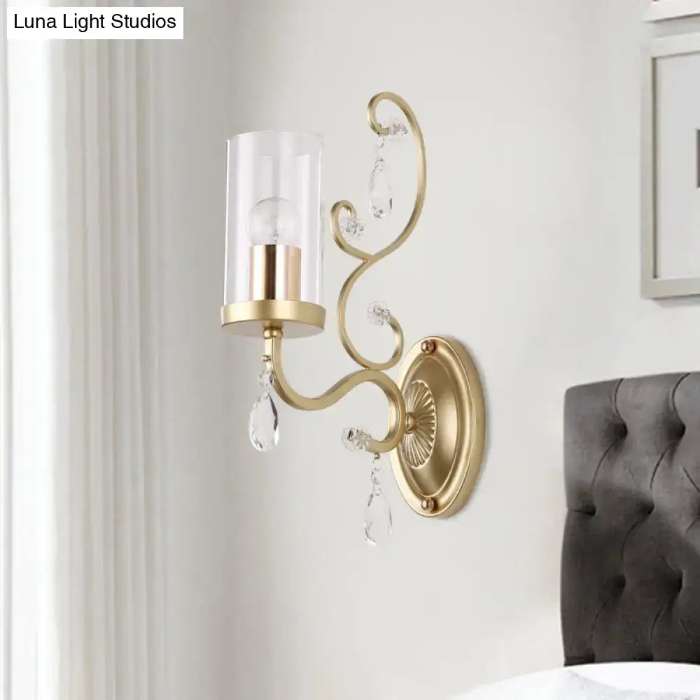Gold cylinder wall light with curved arm, glass shade and crystal drops by Decorbites on Tampa Home & Garden Store