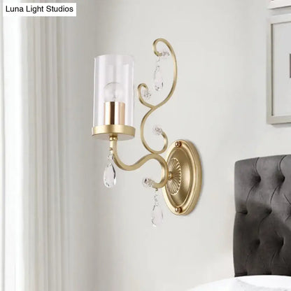 Gold cylinder wall light with curved arm, glass shade and crystal drops by Decorbites on Tampa Home & Garden Store