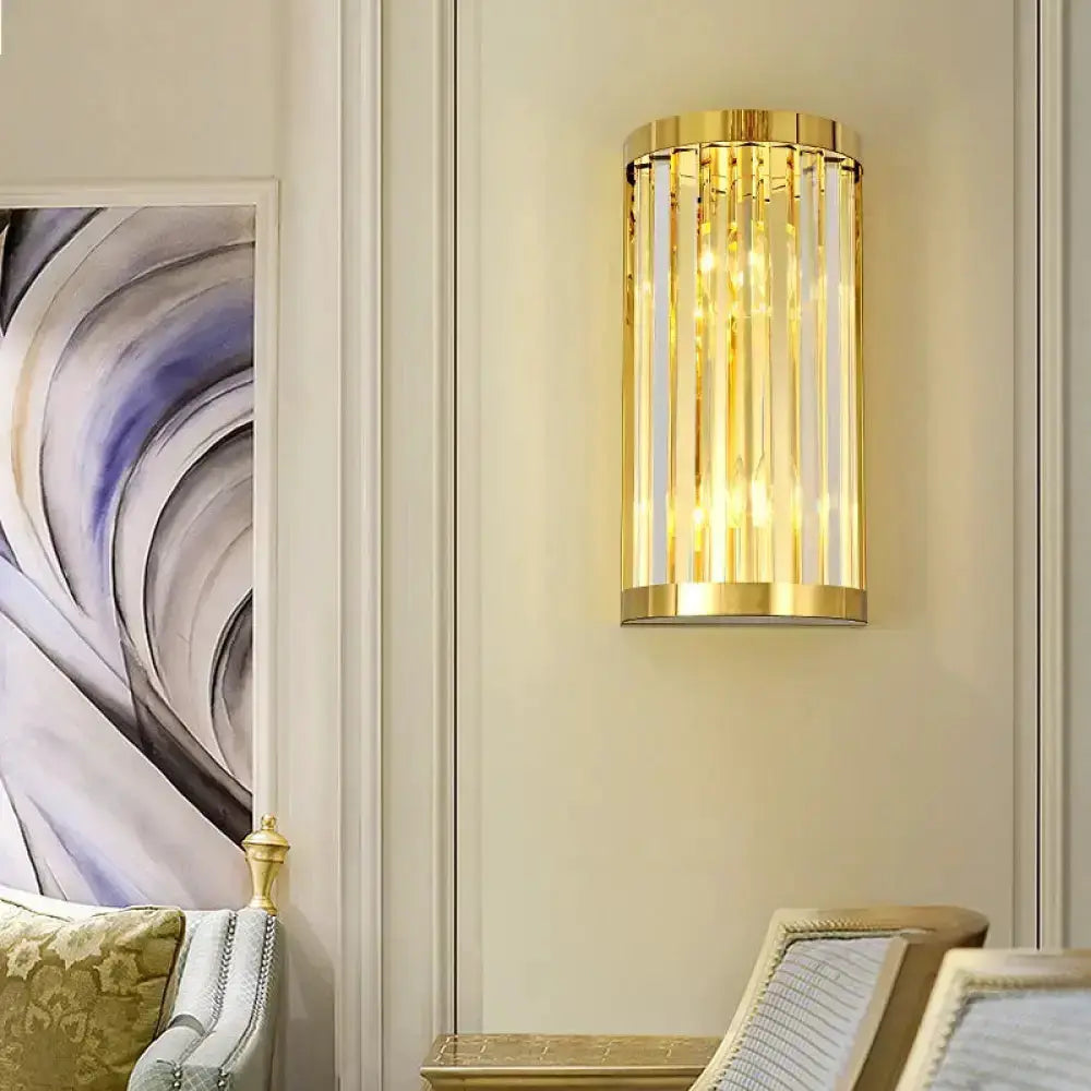 Modern gold crystal wall sconce by Decorbites, gold cylindrical frame with hanging prisms on Tampa Home & Garden Store